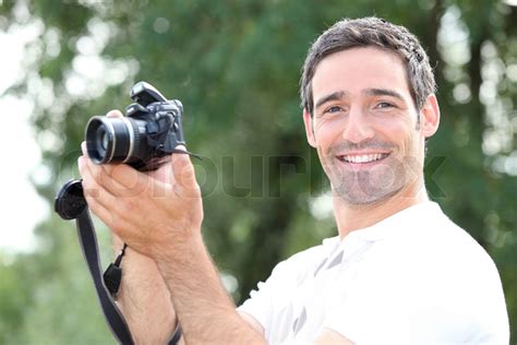 Man Taking A Photo With A Dslr Camera Stock Image Colourbox