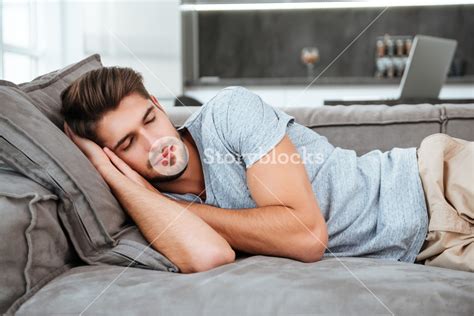 Picture Of Tired Man Sleeping On A Sofa Eyes Closed Royalty Free