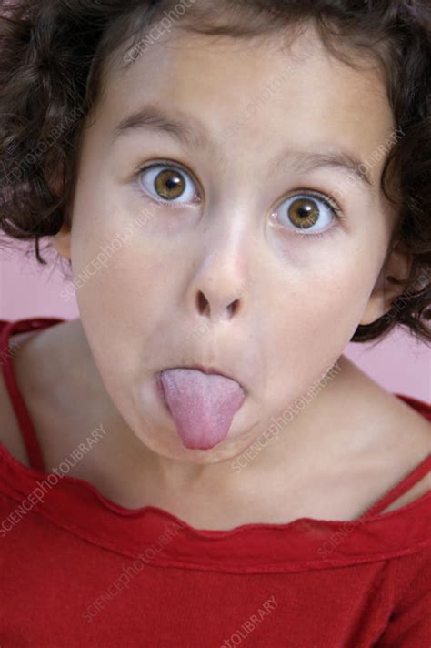 girl sticking out her tongue stock image p701 0480 science photo library