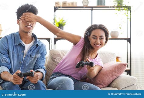 Teenage Couple Enjoying Playing Videogame On Playstation Stock Image