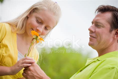 Dad Giving His Daughter A Flower Stock Photo Royalty Free Freeimages