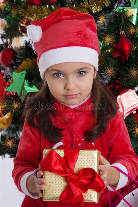 Girl In Santa Hat Holding Christmas T Stock Photo Image Of