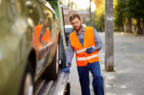 Tow Truck Worker Checking Car Loading Accuracy Stock Image Image Of