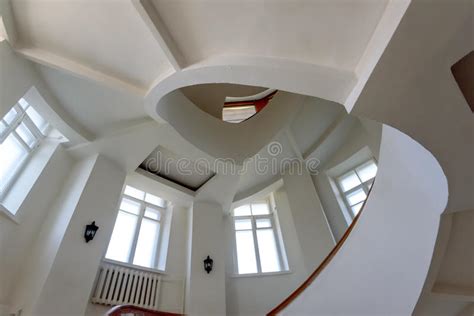 Spiral Staircase With Yellow Banisters And White Walls Editorial Stock