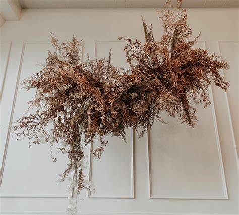 Glue or tape string to the backside of the flower. hanging floral install using all found + dried materials ...