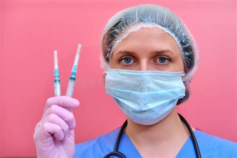 Woman Doctor Holds Syringes In His Hand On A Pink Background Concept Female Nurse With