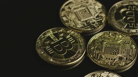Concerns in china centered on a number of issues. Golden bitcoin coins rotating on a black surface - Free ...