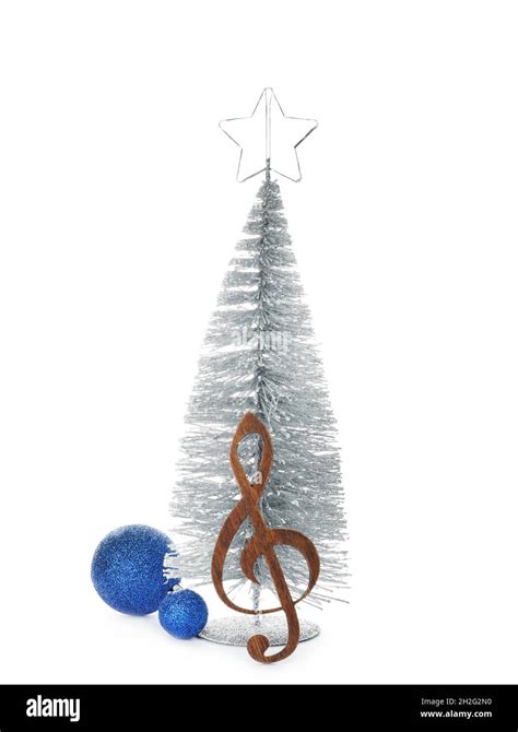 Composition With Small Christmas Tree Decor And Wooden Music Note On