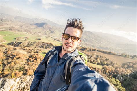 Handsome Hiker Taking A Selfie On The Top Of A Mountain Concept About