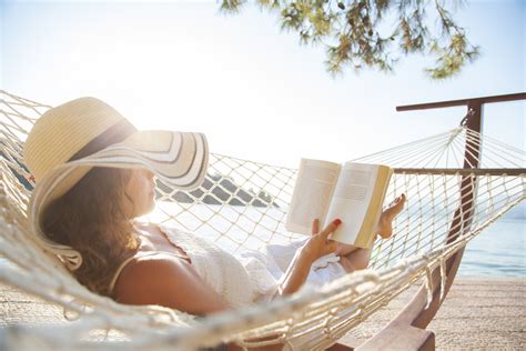Woman In A Hammock With Book On Holiday Humanitas Salute