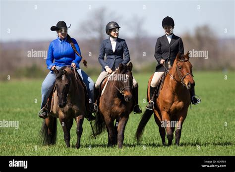Three Women Riding Horses Together Across A Field Stock Photo Alamy