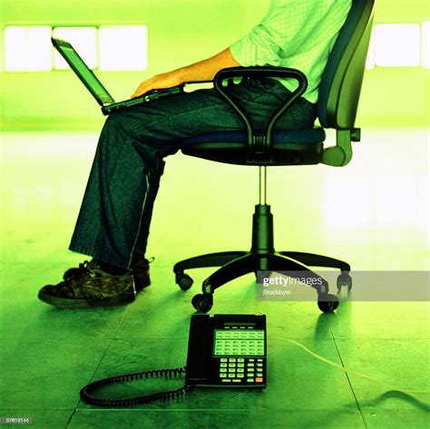 Young Man Sitting On A Chair Working On A Laptop Stock Photo Getty Images