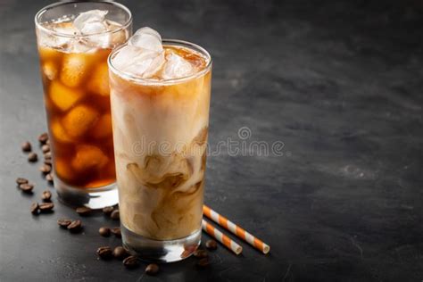 Ice Coffee In A Tall Glass With Cream Poured Over Brown Sugar And