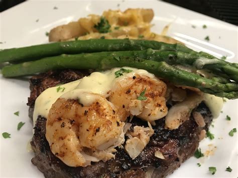Tomahawk rib beef steak on grill. Steak Oscar, Grilled Rib Eye, Crab Claw Meat, Grilled ...