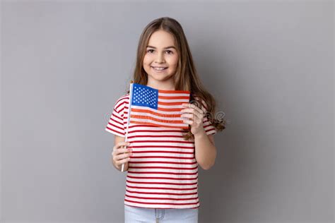 Happy Adorable Cute Little Girl Wearing Striped T Shirt Holding Flag Of