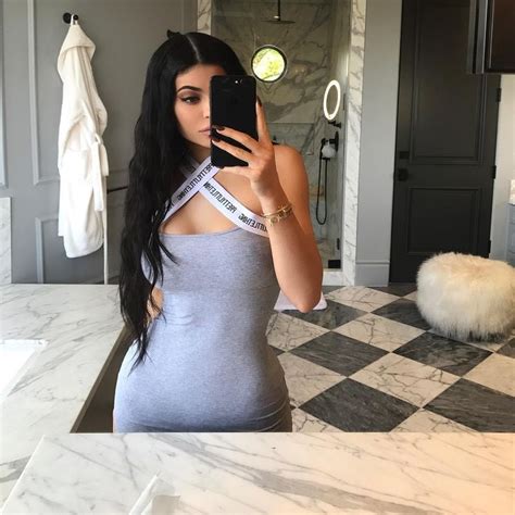 kylie takes a selfie in her bathroom while wearing a grey prettylittlething dress kylie