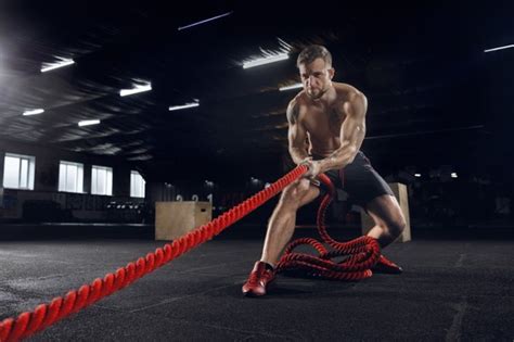 Free Photo Young Healthy Man Athlete Doing Exercise With The Ropes