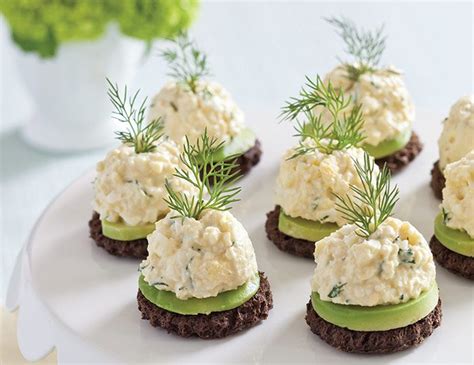 Small Appetizers With Cucumber And Dill Are Arranged On A White Plate