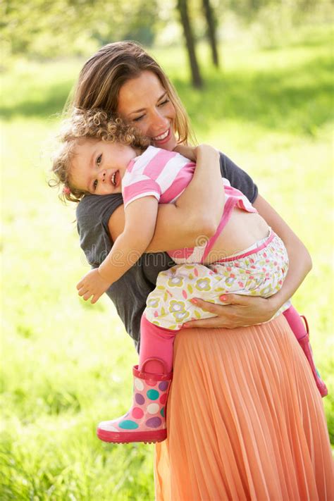 Mother Carrying Young Daughter Stock Image Image 26105523