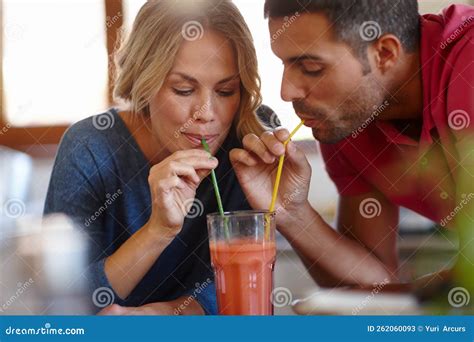 Romance Is Thirsty Work A Happy Young Couple Sharing A Milkshake