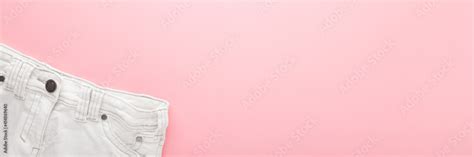 Female White Jeans On Light Pink Table Background Pastel Color