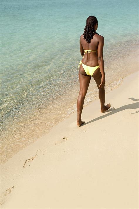 Woman Walking Along A Beach Photograph By Ian Hootonscience Photo