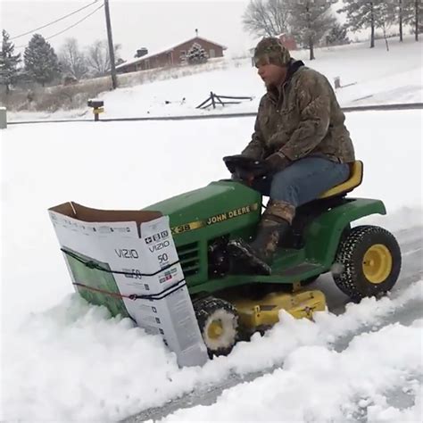 Clever Man Plows Snow Using A Large Cardboard Tv Box Attached To The