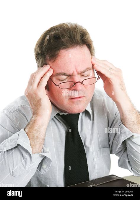 Closeup Of A Businessman Rubbing His Temples To Relieve A Headache