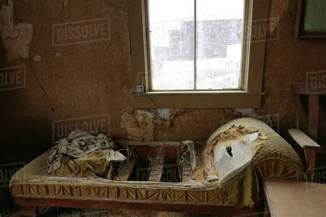 Torn Up Yellow Mattress Decaying In An Abandoned Country House In A