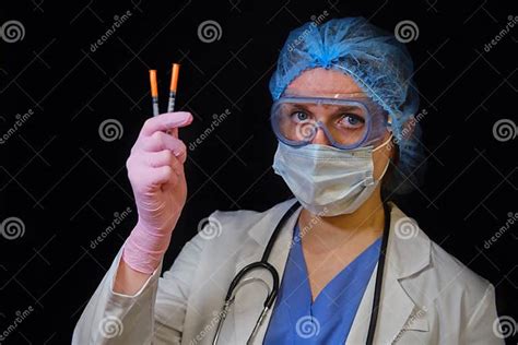 Woman Doctor Holds Syringes In His Hand On A Black Background Concept Female Nurse With