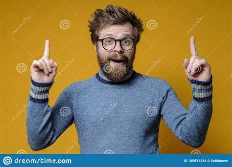 Great Idea Shaggy Bearded Man With Glasses And A Blue Sweater Raises