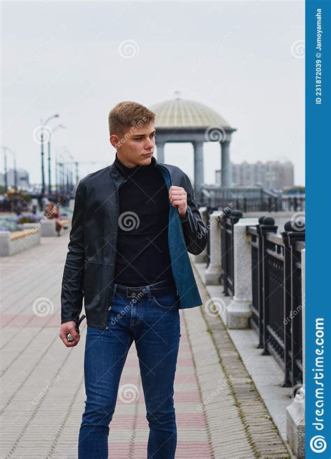 One Handsome Young Man On A City Embankment In A Modern City Walking