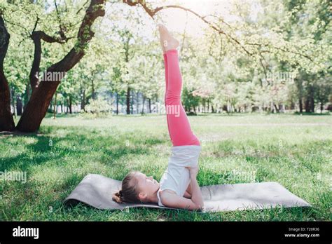 Girl Is Holding Her Legs Up In The Air And Balancing She Is Supporting