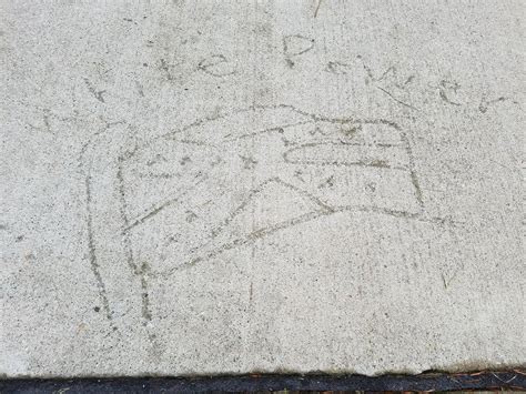 city removes white supremacist graffiti etched into sidewalk