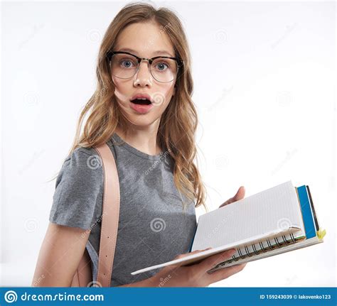 Stunned Teen Girl In Glasses Holding Spiral Notebook Stock Image