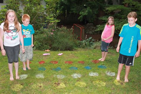 Outdoor Twister Game Spray Paint 6 Rows Of 4 Colours Onto The Lawn