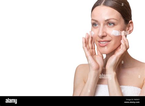 Portrait Of Beautiful Woman Applying Some Cream To Her Face For Skin