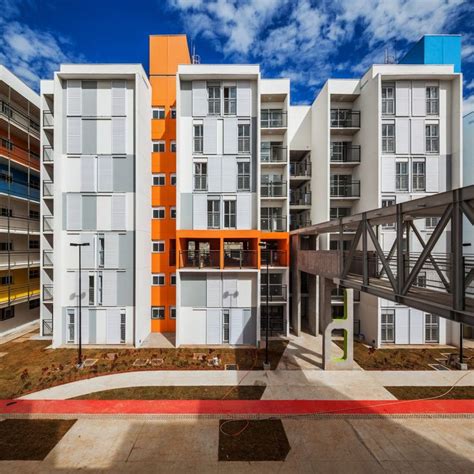 An Apartment Building With Orange And White Accents