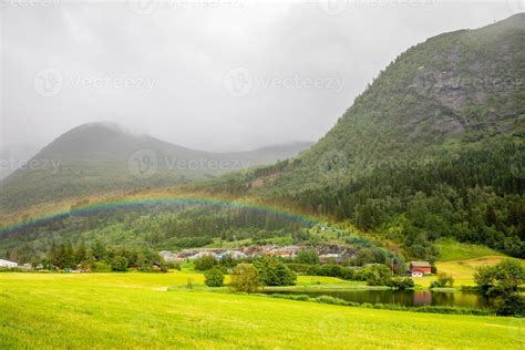 Colorful Rainbow Over The Fields Lake And Houses Of Skei Village