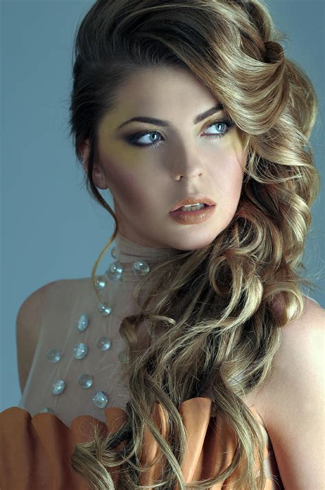 Portrait Of Beautiful Female Model On Light Blue Background Photograph