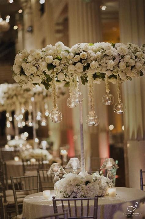 This is a chic and modern option, but we would recommend using a even pomander balls decorated with crystals. white floral chandelier | Floral wedding decorations ...