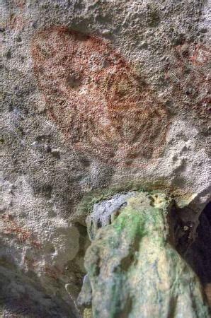 A Rock With Some Green And Red Paint On It