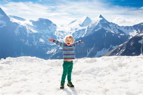 Child Hiking In Mountains Kids In Snow In Spring Stock Photo Image
