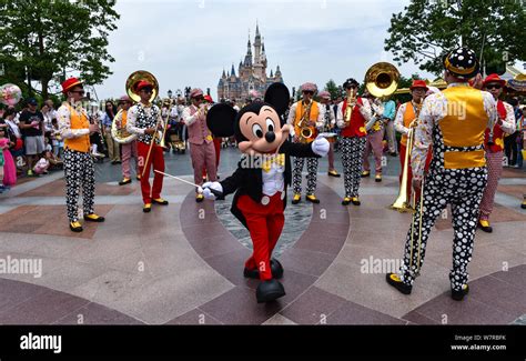 An Entertainer Dressed In A Mickey Mouse Costume Performs During A
