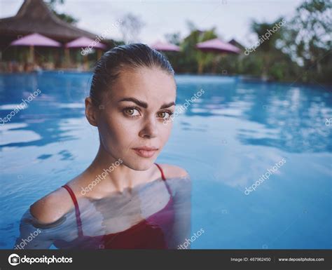 Attractive Woman Swimming In The Pool In A Red Bathing Suit Close Up