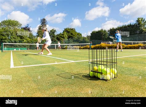 Mature Women Playing Tennis On Grass Court Stock Photo Alamy