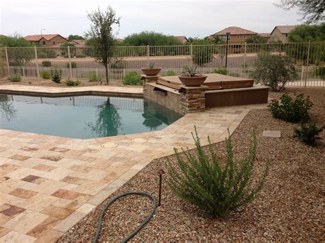 With a fence that places the planks of wood horizontally rather than vertically, you end up with a backyard area that looks like it's an extension of the home itself. Poolside Plants For Arizona Landscape Design