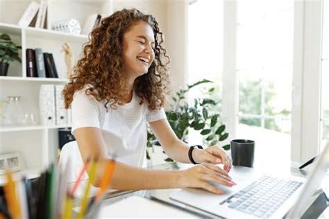 Pretty Young Entrepreneur Woman Working With Laptop Sitting In The