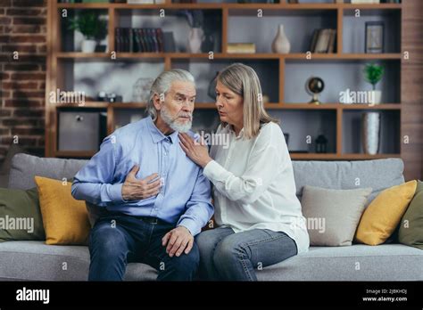 Senior Mature Woman Helping Her Husband With Chest Pain Old Man