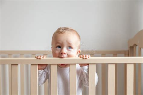 Blond Cute Little Baby Biting Wooden Bed Headboard Stock Photo Image